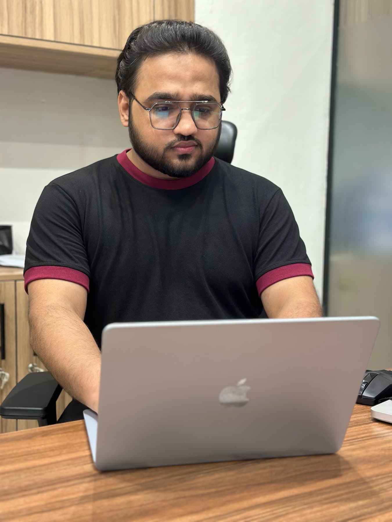 A 02X teammate at a studio desk