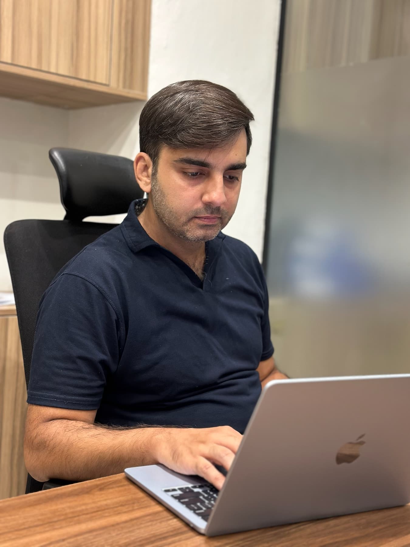 A 02X teammate reviewing work on a laptop